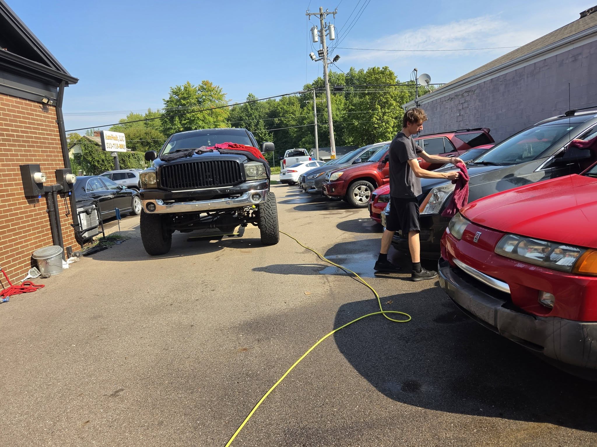 Detailer working outside on a vehicle